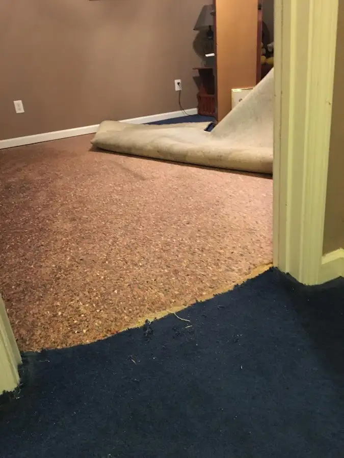 Carpet pad removal revealing water damage during Drying & Dehumidification in Kingman